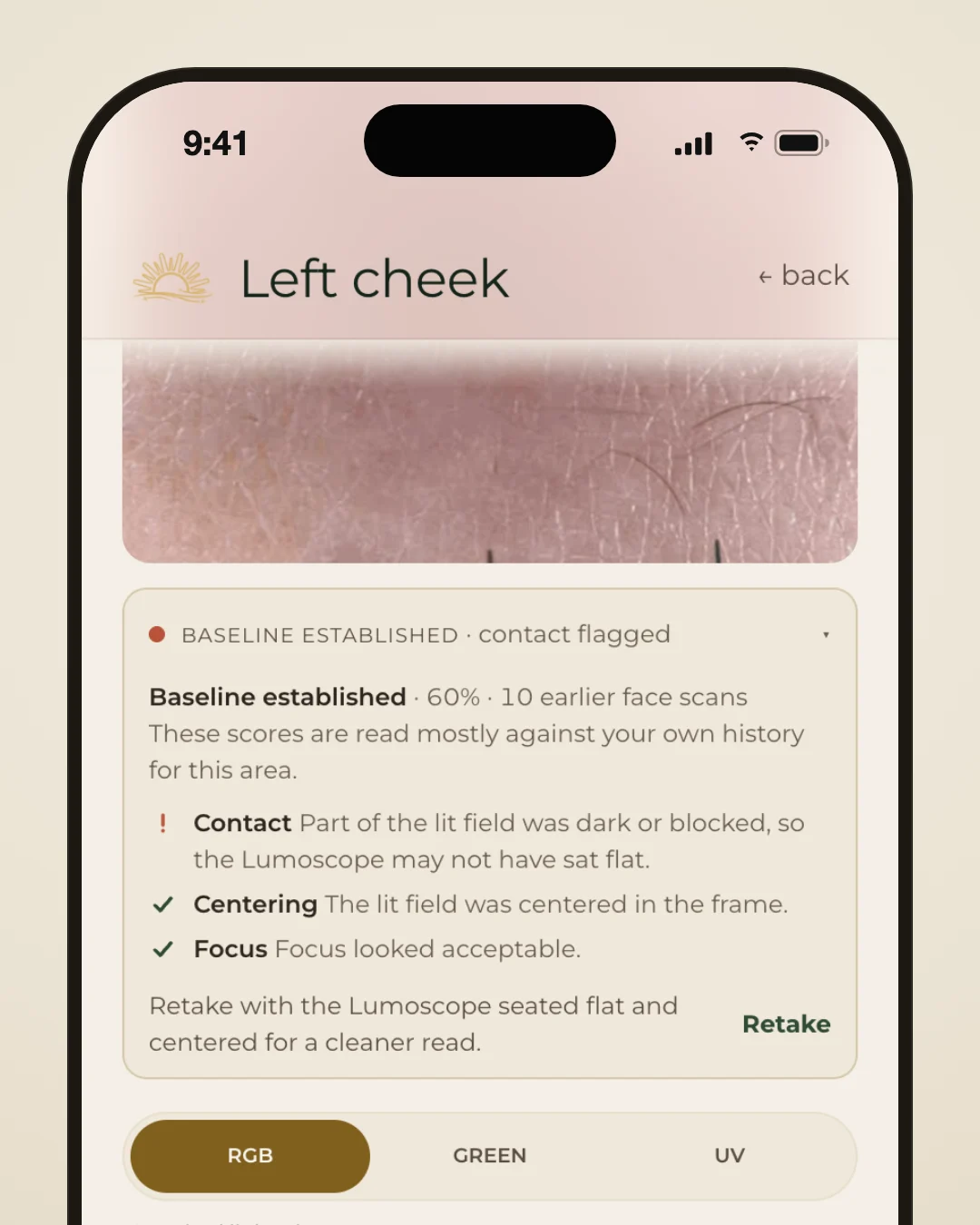 Lumeria app scan result for the left cheek: capture checks with Contact flagged and Centering and Focus passed, and a Retake button.